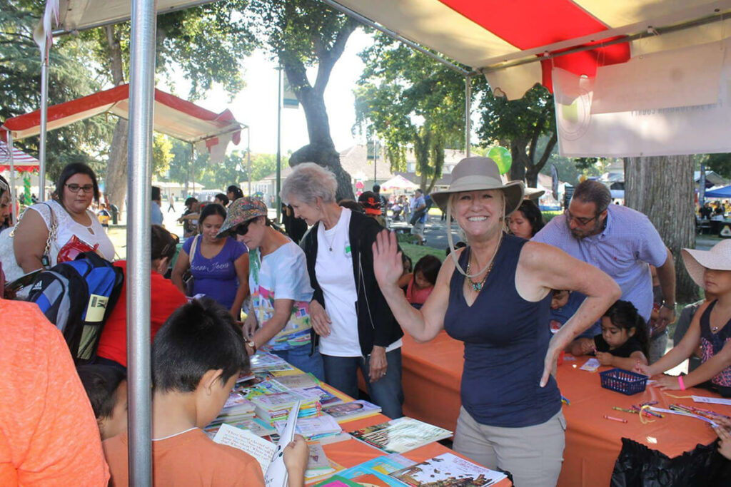 Board Member Susan Ollis helps distribute books.